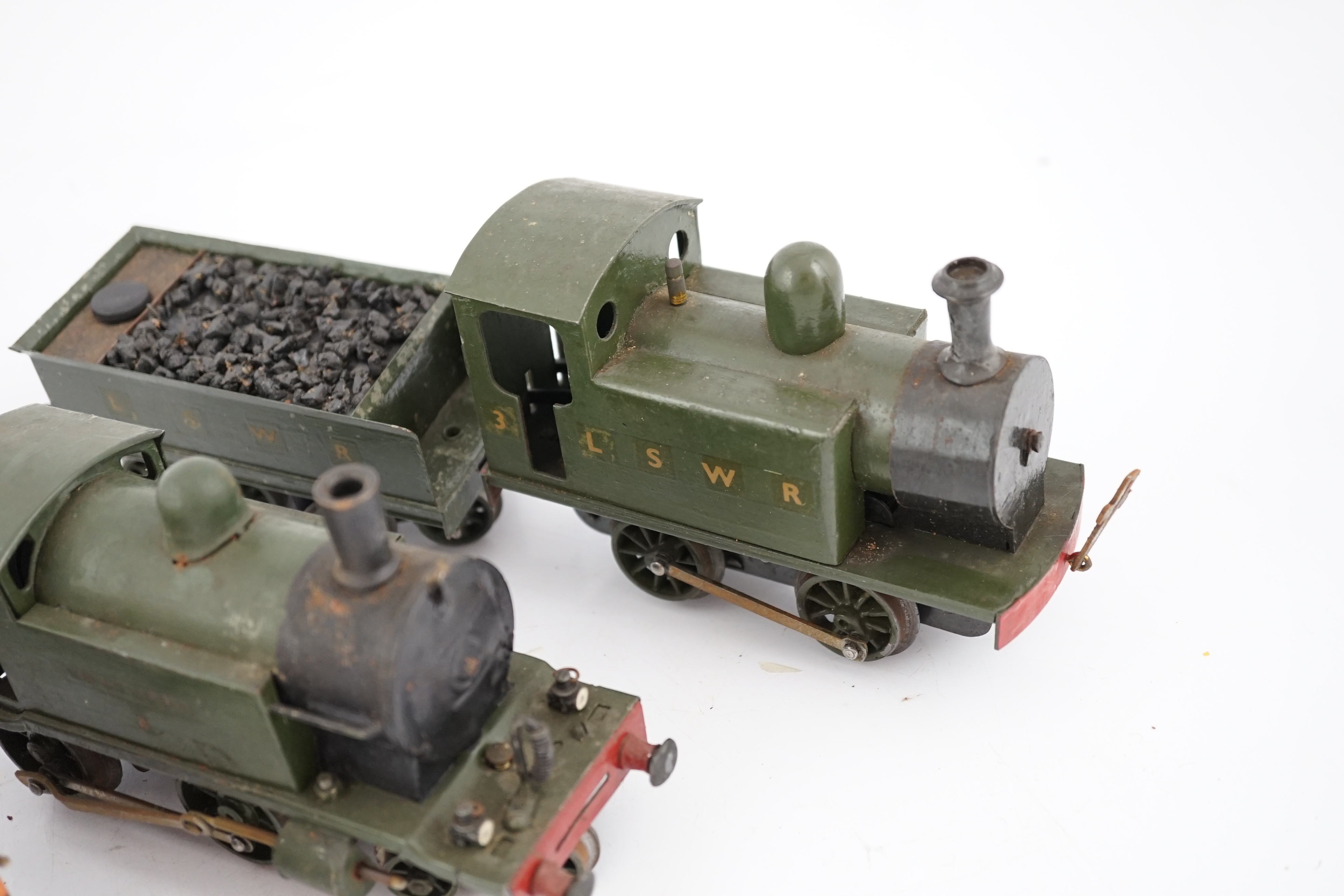 Fifteen tinplate 0 gauge railway items, including three clockwork locomotives; an LSWR 0-4-2 tender loco, an LSWR 0-4-0T and a SR 4-4-0T, all built using some commercial parts with some elements scratch built